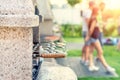 Outdoor stone stove with grill and skewers. Company of friends at barbecue party at park or backyard with green grass lawn and Royalty Free Stock Photo