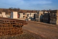 Outdoor storage with a pile of rusty grooved rails for tram tracks and railway sleepers.