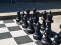 Outdoor street chess board with big black plastic pieces