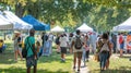 Outdoor summer fair with diverse people walking between booths