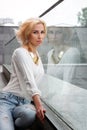 Outdoor summer fashion stunning portrait on pretty young blonde woman dressed in a white shirt and torn jeans having fun in t Royalty Free Stock Photo