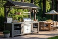 outdoor summer kitchen with long barbecue and table with dishes