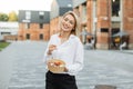 Outdoor summer portrait of cheerful blonde woman freelancer enjoying her tasty salad Royalty Free Stock Photo