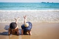 Outdoor summer portrait of the front image of two Asian beautiful girls in a sexy bikini lie down on the beach Royalty Free Stock Photo