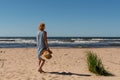 Outdoor summer portrait of a woman on the tropical beach looking out to sea, enjoying her freedom and fresh air, wearing a stylish Royalty Free Stock Photo