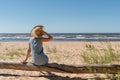 Outdoor summer portrait of a woman on the tropical beach looking out to sea, enjoying her freedom and fresh air, wearing a stylish Royalty Free Stock Photo