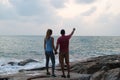 Outdoor summer portrait of young romantic couple in love posing at amazing stone beach, Royalty Free Stock Photo