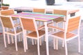 outdoor summer restaurant terrace with tables and wooden chairs closeup photo Royalty Free Stock Photo