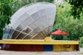 Outdoor summer scene in the city amusement park. A functioning small concert venue. Side view. Rounded spherical roof in Royalty Free Stock Photo