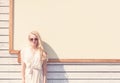 Outdoor summer sensual fashion portrait beautiful young blond woman of a white dress in sunglasses on the street on the background Royalty Free Stock Photo