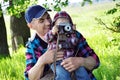 Outdoor summer smiling lifestyle portrait of happy father and little baby girl having fun with retro camera travel photo