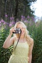 Outdoor summer smiling lifestyle portrait of pretty young blonde Royalty Free Stock Photo