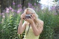 Outdoor summer smiling lifestyle portrait of pretty young blonde Royalty Free Stock Photo