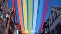 Outdoor sun protection in the form of an artificial rainbow between houses, Germany