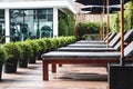 Outdoor sunbathing deck chair at resort swimming pool