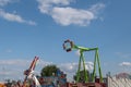 Outdoor sunny view of pendulum amusement ride, rotate and swing down and up
