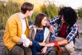 Outdoor Support Circle: Friends Attend to Injured Companion Royalty Free Stock Photo