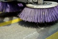 Outdoor sweeper. using round brushes with plastic purple brushes. Cleaning gravel and clutter in the city streets after constructi