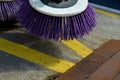 Outdoor sweeper. using round brushes with plastic purple brushes. Cleaning gravel and clutter in the city streets after constructi