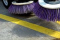 Outdoor sweeper. using round brushes with plastic purple brushes. Cleaning gravel and clutter in the city streets after constructi