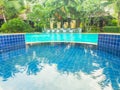Outdoor swimmimg pool with waterfall Royalty Free Stock Photo