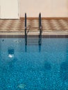 outdoor swimming pool with blue water and lader