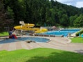 Empty outdoor swimming pool landscape with slide summer season Royalty Free Stock Photo