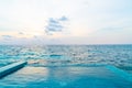 outdoor swimming pool with ocean sea and sunset sky background Royalty Free Stock Photo