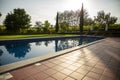 Outdoor swimming pool on the open air with beautiful view to the garden. Royalty Free Stock Photo