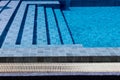 Outdoor swimming pool steps with clear water surface background, nobody, underwater pattern blue background with grid tiles, Royalty Free Stock Photo