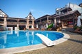 An outdoor swimming pool for visitors against the backdrop of wooden buildings in a medieval style Royalty Free Stock Photo