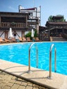 An outdoor swimming pool for visitors against the backdrop of wooden buildings in a medieval style Royalty Free Stock Photo