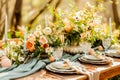 An outdoor table is arranged with flowers for spring events. Royalty Free Stock Photo