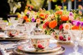 An outdoor table is set elegantly with flowers and fine china. Royalty Free Stock Photo