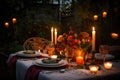 outdoor table setting with candles, plates, and silverware for romantic dinner Royalty Free Stock Photo