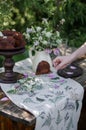 Outdoor table setting. Chocolate cake on a high wooden stand Royalty Free Stock Photo