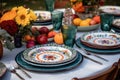 outdoor table settings with hand-painted ceramic plates and silverware Royalty Free Stock Photo
