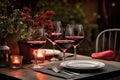 outdoor table settings with wine glasses and bottle of red, for a romantic evening Royalty Free Stock Photo