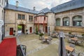 Outdoor tables fill a patio courtyard inside a medieval chateaux hotel in the Normandy  city of Rouen, France Royalty Free Stock Photo