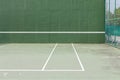 Outdoor tennis court and green knock board with white lines for personal practice