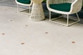 Outdoor terrace area with beige floor tile with sitting area. Ceramic granite tile fooring. Garden decoration Royalty Free Stock Photo