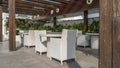 Outdoor terrace in the cafe. White wicker chairs and round tables Royalty Free Stock Photo