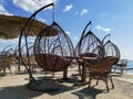 Outdoor terrace with Empty wooden table and chair with Sea view. Hanging chairs, table at the terrace