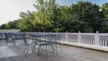 Outdoor terrace for relaxing. Elegant metal chairs and tables stand in a row. Royalty Free Stock Photo