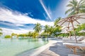 Luxury poolside with beach background, beach chair around swimming pool in hotel resort with sea beach background, holiday Royalty Free Stock Photo