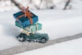Outdoor toy vintage retro car with gifts for Christmas and New Year, car on a snowy road. Sunny frosty winter day, a lot of snow Royalty Free Stock Photo