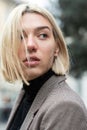 Outdoor urban female portrait. Fashion model. Young woman posing in Milan streets. Beautiful caucasian girl with blond hair Royalty Free Stock Photo