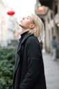 Outdoor urban female portrait. Fashion model. Young woman posing in Milan streets. Beautiful caucasian girl with blond hair Royalty Free Stock Photo