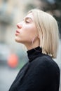 Outdoor urban female portrait in profile. Fashion model. Young woman posing in Milan streets. Beautiful caucasian girl with blond Royalty Free Stock Photo