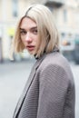 Outdoor urban female portrait, soft focus. Fashion model. Young woman posing in Milan streets. Beautiful caucasian girl with blond Royalty Free Stock Photo